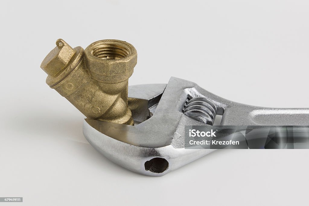 adjustable wrench and a pipe wrenches with land water pipe on a white background Business Stock Photo