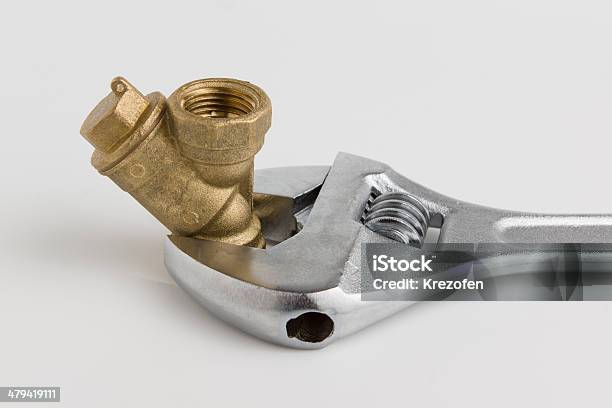 Adjustable Wrench And A Pipe Stock Photo - Download Image Now - Business, Chrome, Construction Industry