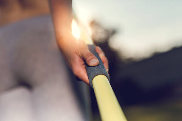 close up of a human hand holding javelin. - javelin sport photography outdoors стоковые фото и изображения