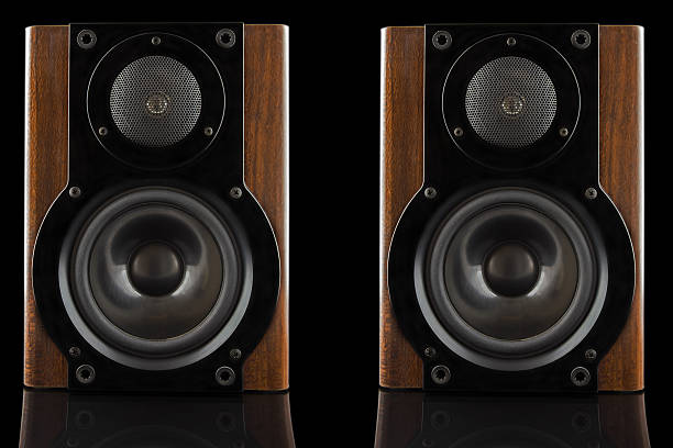 Pair of modern sound speakers Pair of modern sound speakers in classic wooden casing isolated on black background home cinema system stock pictures, royalty-free photos & images