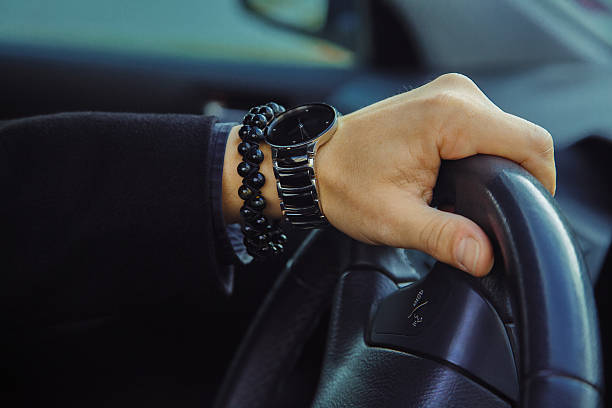 farbbild von erwachsenen männlichen hand mit uhr und armband - people speed mode of transport black and white stock-fotos und bilder