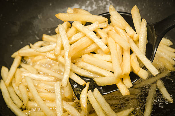 istock French fries in a hot pan. 479426131