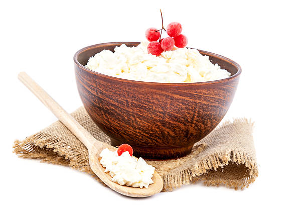 istock Cottage cheese in a bowl with a wooden spoon. 479430992
