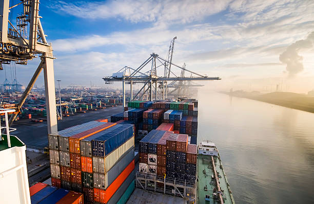 Container operation in port. Sunrise in busy container terminal in Rotterdam, Netherlands. container stock pictures, royalty-free photos & images