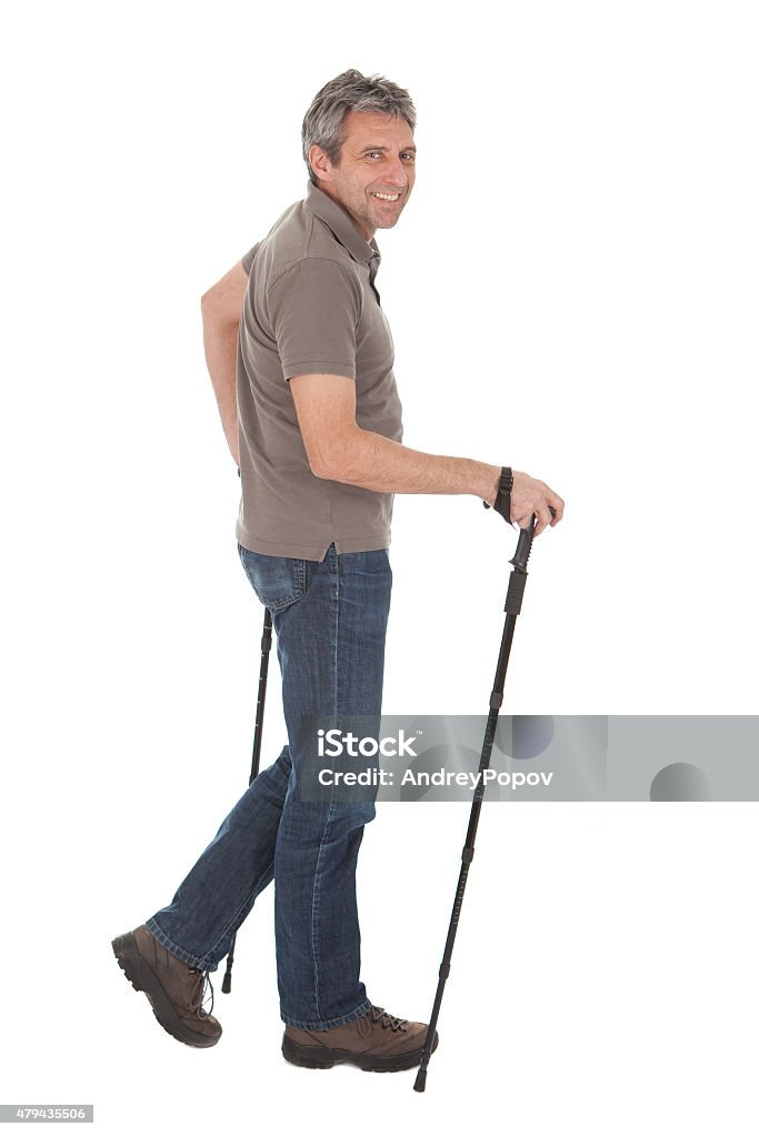 Senior man with hiking poles Portrait of senior man with hiking poles. Isolated on white 2015 Stock Photo