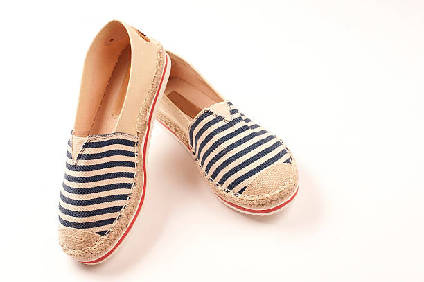 Pair of beige espadrilles with blue and red pattern