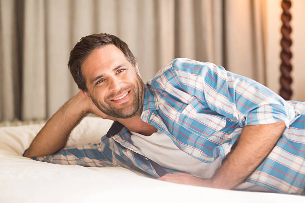 istock Handsome man relaxing on his bed 479438378