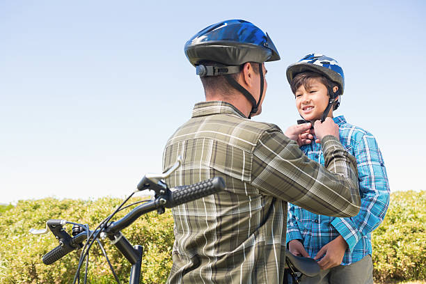 istock Father attaching his son cycling helmet 479438920