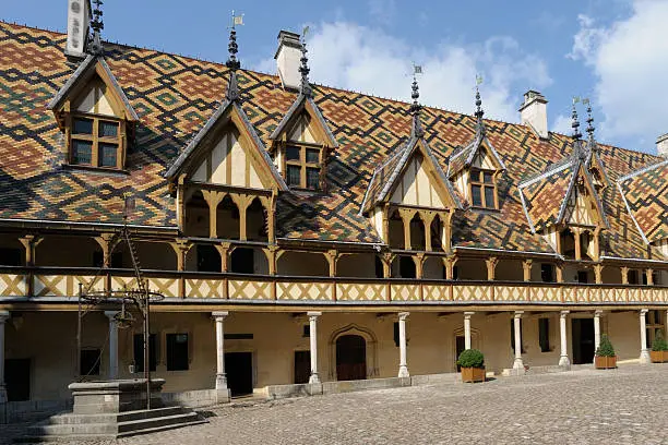 with typical polychrome tiles of Burgundy and wood wall stud.