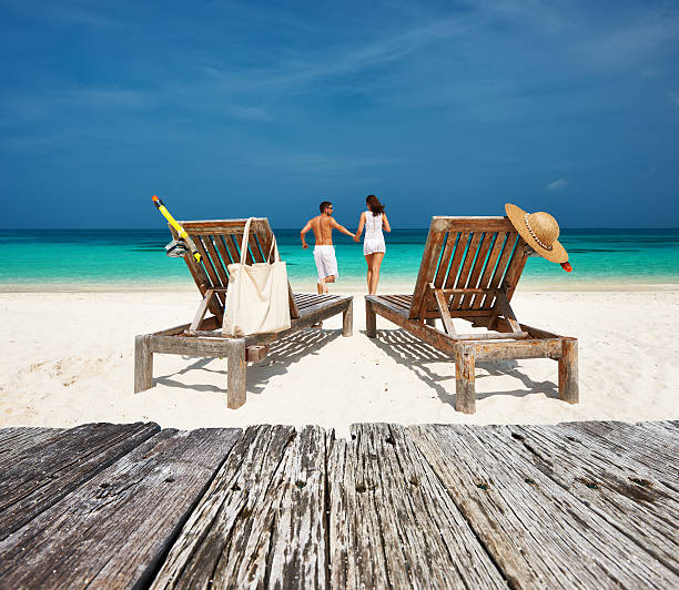 istock Couple in white relax on a beach at Maldives 479441680