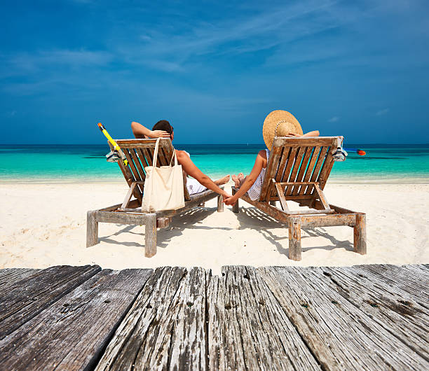 istock Couple in white relax on a beach at Maldives 479441682