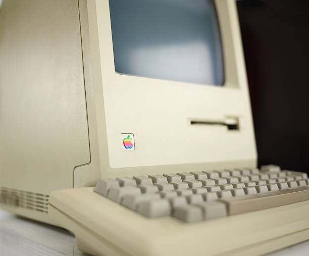 Apple Macintosh 128k from 1984, the vintage iMac Aachen, Germany - March 14, 2014: Studioshot of an original Macintosh 128k called Apple Macintosh. This was the first produced Mac, released on january 1984 ergonomic keyboard photos stock pictures, royalty-free photos & images