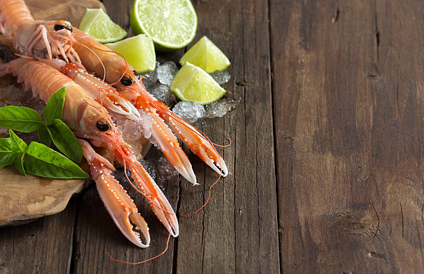 istock Raw langoustine on ice with lime and basil 479442368