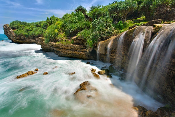 Beautiful Jogan waterfall falling to the ocean stock photo
