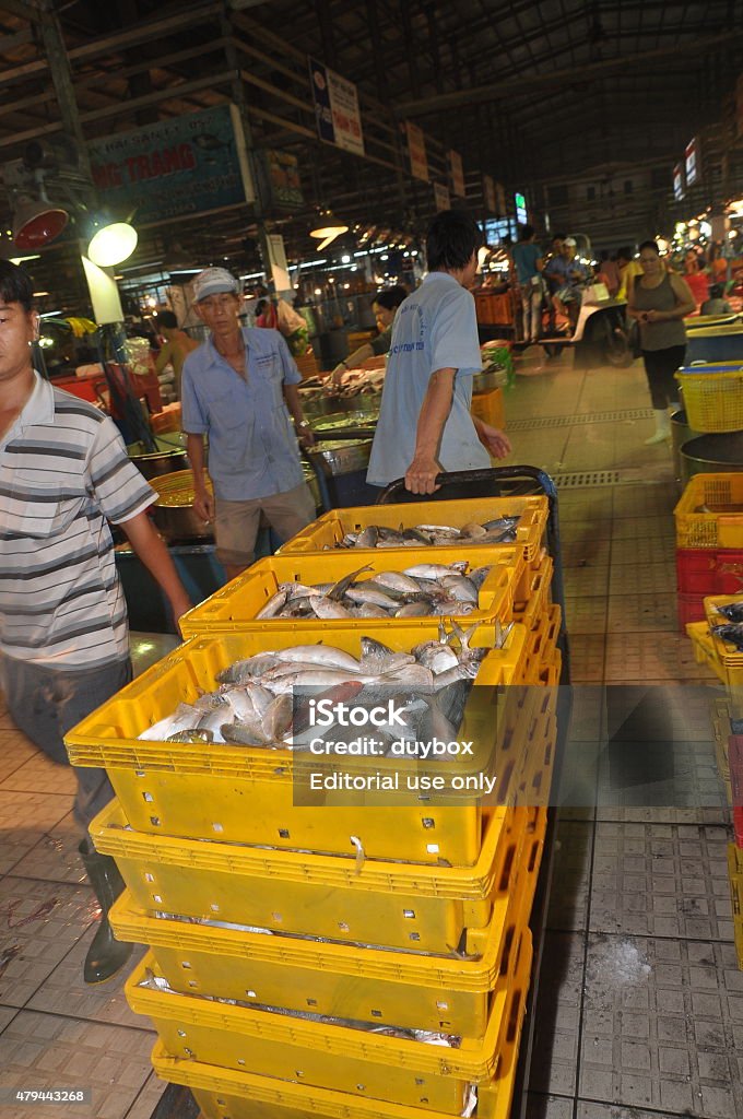 People are purchasing at a local seafood market Ho Chi Minh City, Vietnam - November 28, 2013: Plenty of fisheries in baskets are waiting for purchasing at the Binh Dien wholesale night seafood market, the biggest one in Ho Chi Minh city, Vietnam 2015 Stock Photo