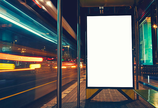 Public information board with blurred vehicles in high speed Illuminated blank billboard with copy space for your text message or content, advertising mock up banner of bus station, digital viewfinder stock pictures, royalty-free photos & images