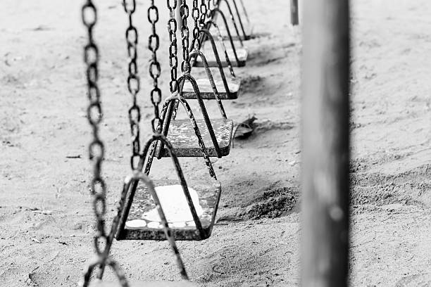 istock monochromeand white view Empty chain swings on summer kids 479444572