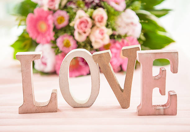 istock LOVE in front of flower bouquet 479452634