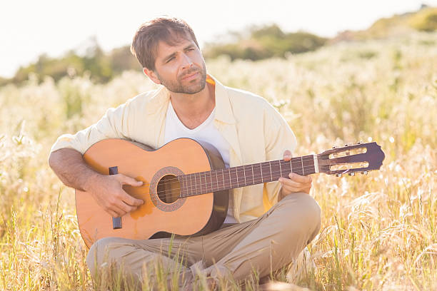 istock Happy man smiling and playing guitar 479455688