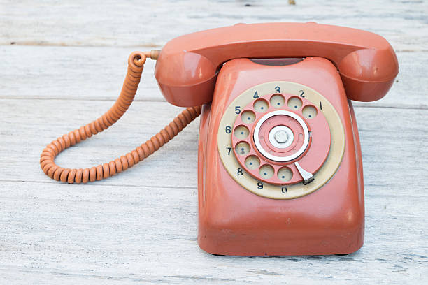 istock Retro rotary telephone on wood table 479456410