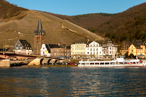 Bernkastel-Kues, Germany - March 9, 2014: Cityscape from Bernkastel-Kues on the Mosel. The visitor is a wealth of attractions, including magnificently decorated, well-preserved half-timbered houses, the Renaissance Town Hall and the Renaissance fountain in the square, the early Gothic St. Michael's Church. with magnificent Baroque organ and the resultant of the old fort gate Graacher In the summer of Bernkastel-Kues is visited by tourists from all countries. River Mosella next parking are also berths for passenger ships, where you can make little money for a boat tour. In the photo, the passenger ship Europe is seen.
