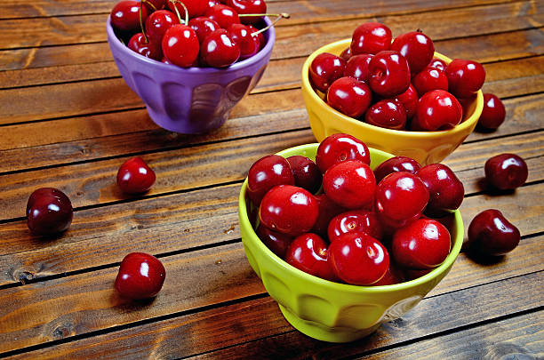 istock Bowl with cherries on wooden table 479459290
