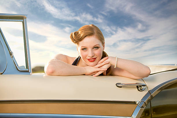Curious redhead woman peeking inside a washing machine, inspecting the appliance before starting a load of laundry, embodying the essence of daily domestic life and housework