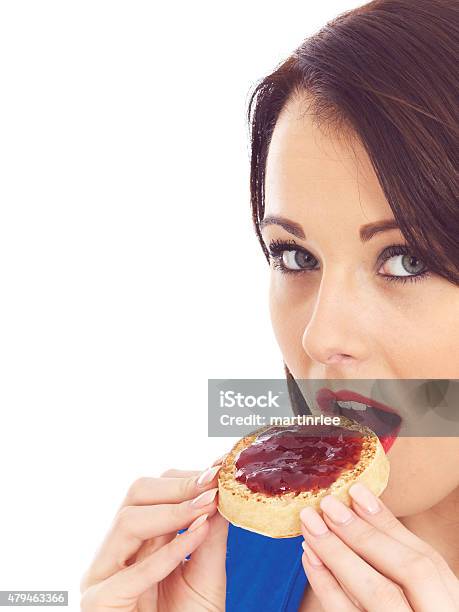Young Woman Eating Toasted Crumpet And Jam Stock Photo - Download Image Now - 2015, Adult, Adults Only