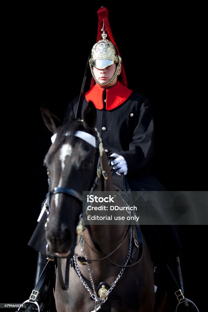 London Guard on Horseback London, UK - March 15, 2014: A mounted Life Guard of the Household Calvary on duty in Whitehall. The Life Guards are one of two regiments in the British Household Calvary, which has a history dating back to the 1660s. They act as the Monarch's personal bodyguard and carry out mounted ceremonial duties on Royal and State occasions. Adult Stock Photo