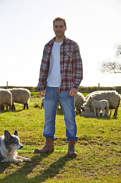 istock Farmer standing infront of a flock of sheep 479469204