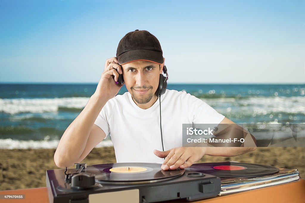 DJ  vinyl record on a  turntable DJ  vinyl record on a  turntable with beach  background Beach Stock Photo