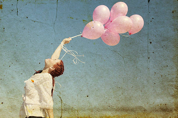 istock woman holding pink balloons 479473631