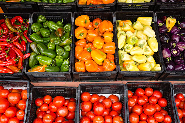 Organic Produce Farmer's Market Farm fresh organic tomatoes and pepper's in a farmer's market located in the Okanagan Valley of British Columbia, Canada. granville island stock pictures, royalty-free photos & images