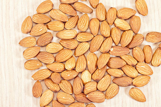 istock Almonds lie on a wooden table 479476824
