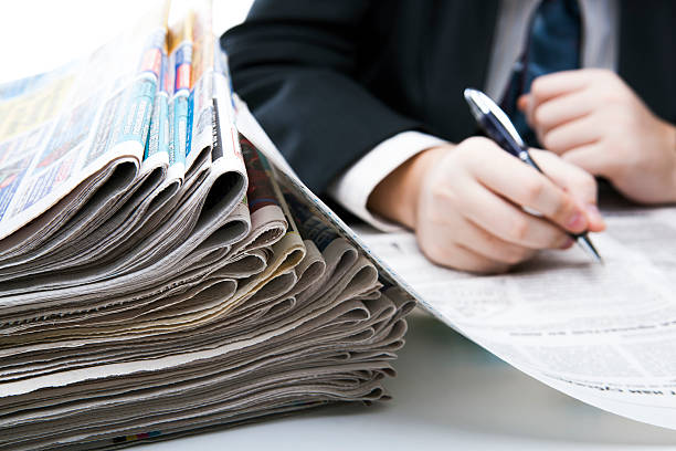 istock stack of newspapers in office close-up 479477131