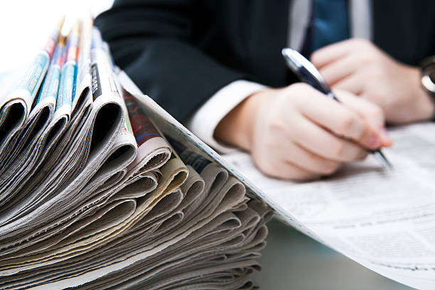 istock stack of newspapers in office close-up 479477145