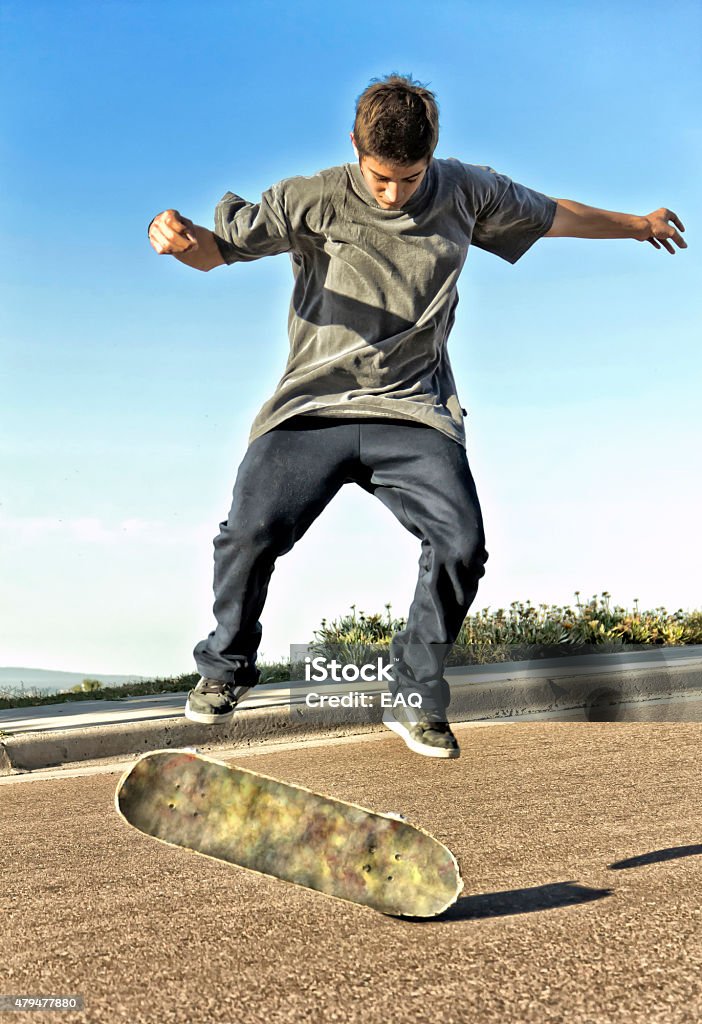 Skateboarding Teen skater, in practice jumping with your skateboard. Adolescence Stock Photo