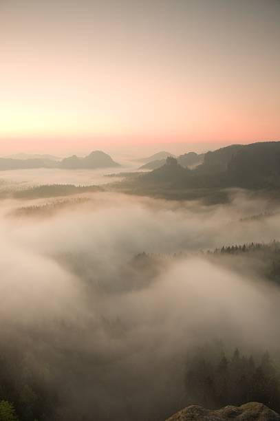 istock Misty view into long deep valley full of spring mist. 479484284