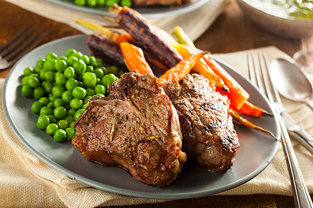 Homemade Cooked Lamb Chops Homemade Cooked Lamb Chops with Peas and Carrots meat chop stock pictures, royalty-free photos & images