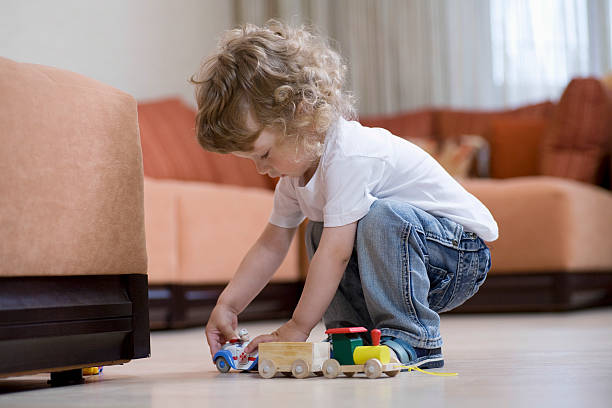 istock Boy Playing With Toy Train In Living Room 479484625