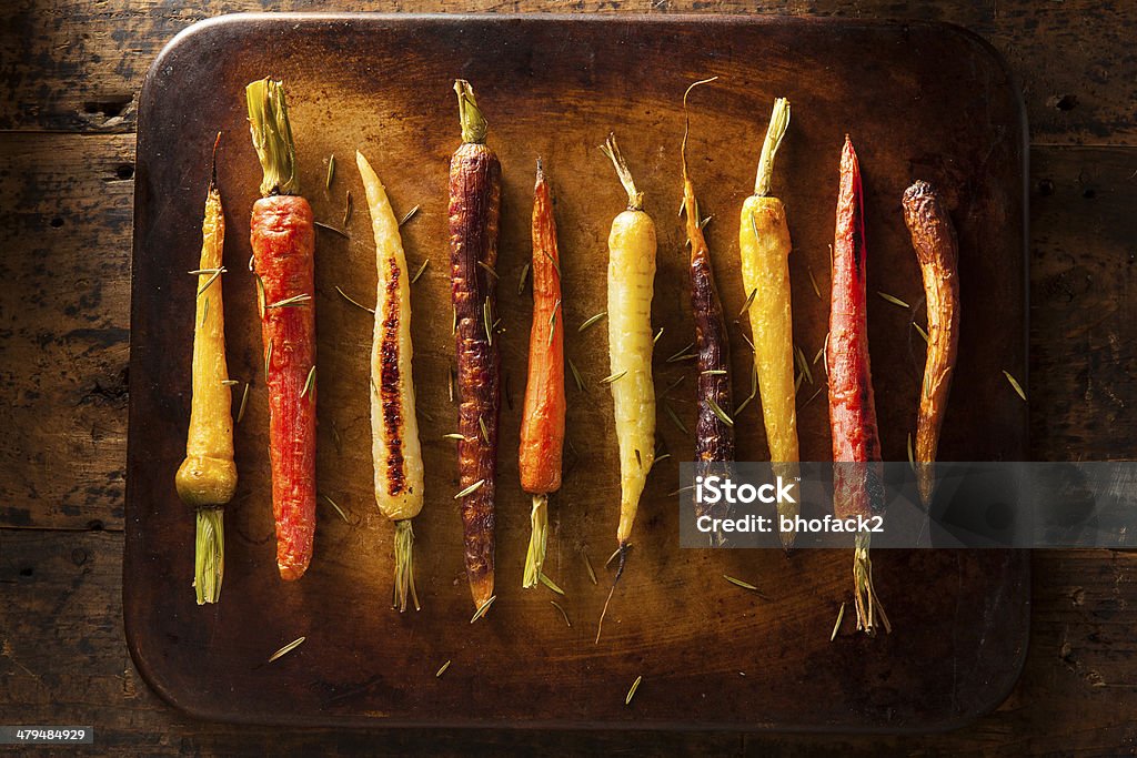 Colorful Multi Colored Roasted Carrots Colorful Multi Colored Roasted Carrots on a Background Bunch Stock Photo