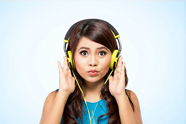 istock Young woman with yellow headphone, isolated 479485412