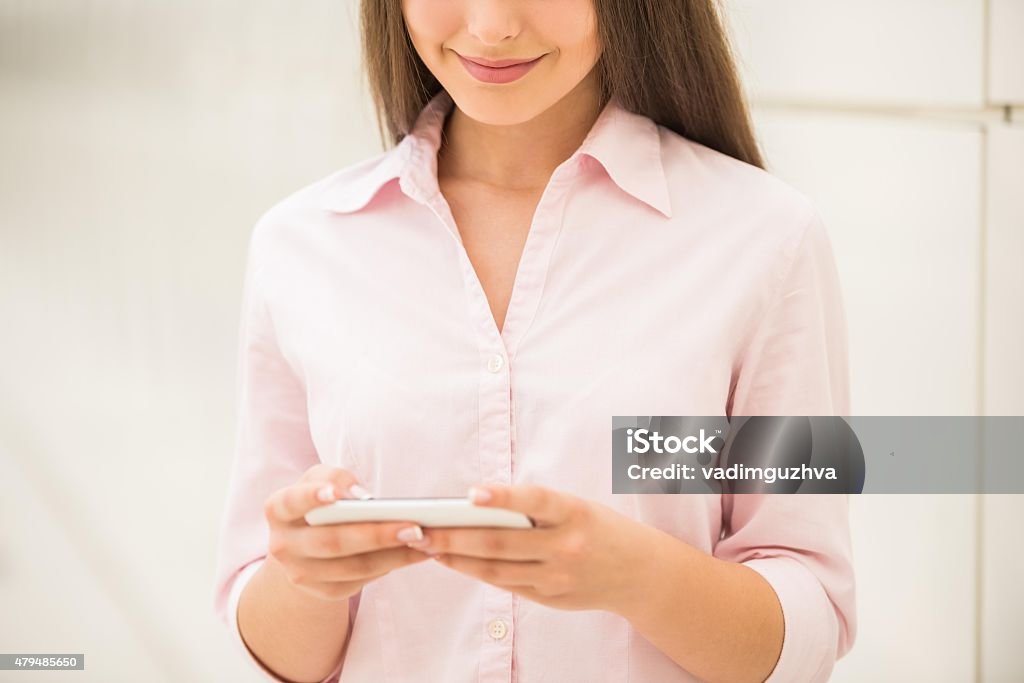 Students with gadgets Close-up photo of young pretty woman using smart phone. 2015 Stock Photo