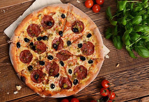 Pizza Tasty pizza with olives and salami pizza topping stock pictures, royalty-free photos & images