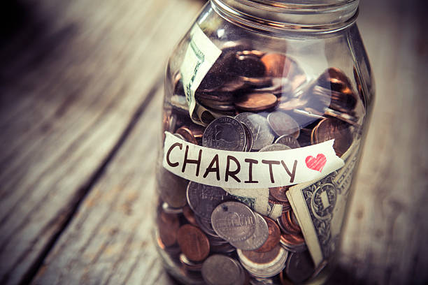 istock Donation jar of money on rustic wood 479488776