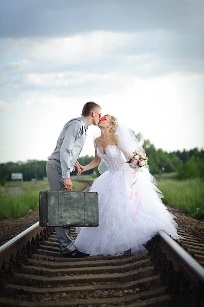 istock bride and groom on railway tracks 479489767