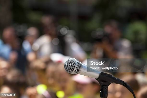 Microphone In Focus Against Blurred Audience Stock Photo - Download Image Now - 2015, Audience, Audio Equipment