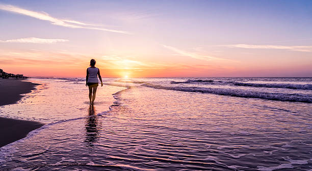 istock Woman at beach with sunrise 479493158