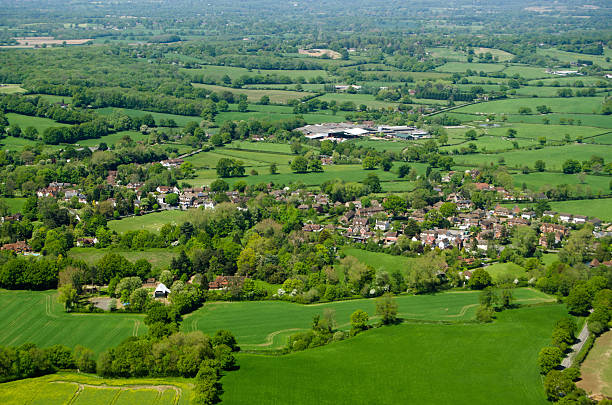 Charlwood village, Surrey, Aerial View View from an airplane of the village of Charlwood inthe Surrey Hills.  A game of cricket is being played in the May sunshine on the village pitch. surrey england stock pictures, royalty-free photos & images