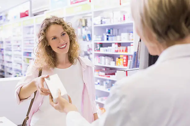 Costumer taking medicine box at pharmacy 